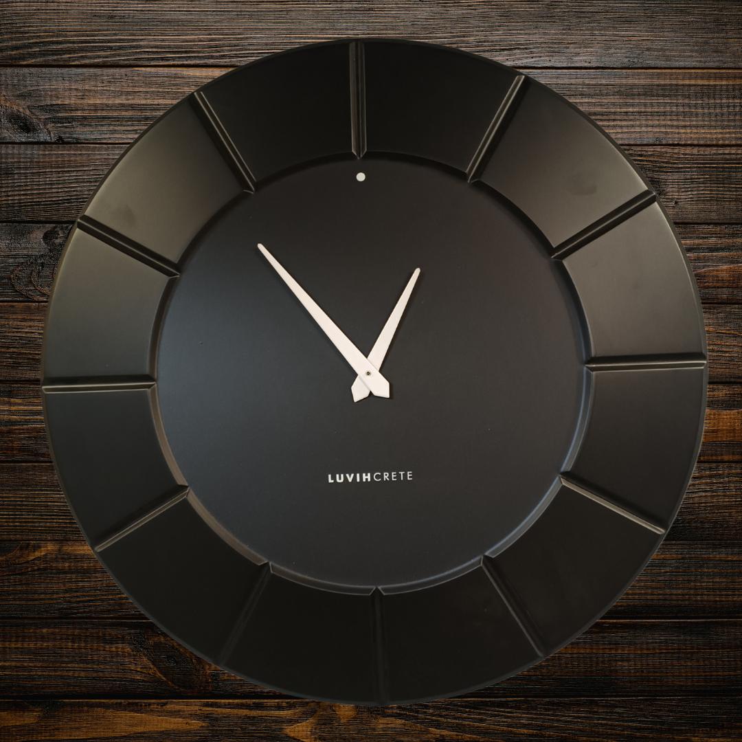 Black HDMR wall clock displayed in modern interior