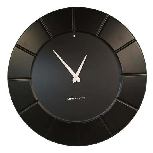 Black HDMR wall clock displayed in modern interior setting