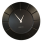 Black HDMR wall clock displayed in modern interior setting